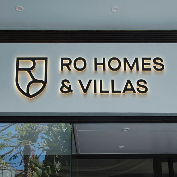 RO Homes & Villas illuminated signage on modern building exterior