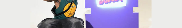 Person posing next to a bright purple ultrathin lightbox sign displaying the phrase Are You Dumb? in bold illuminated letters